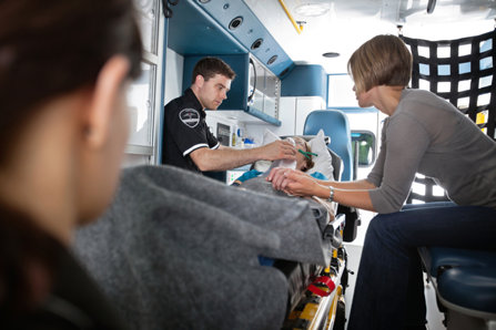 Paramedics and family in the ambulance vehicle.