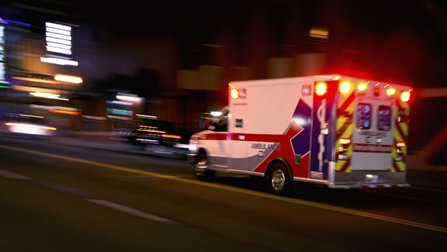 An ambulance rushes through the night to save the life of a person who has overdosed. 